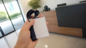 Primeiro dia como jovem aprendiz, mão segurando um crachá novo na recepção de um escritório